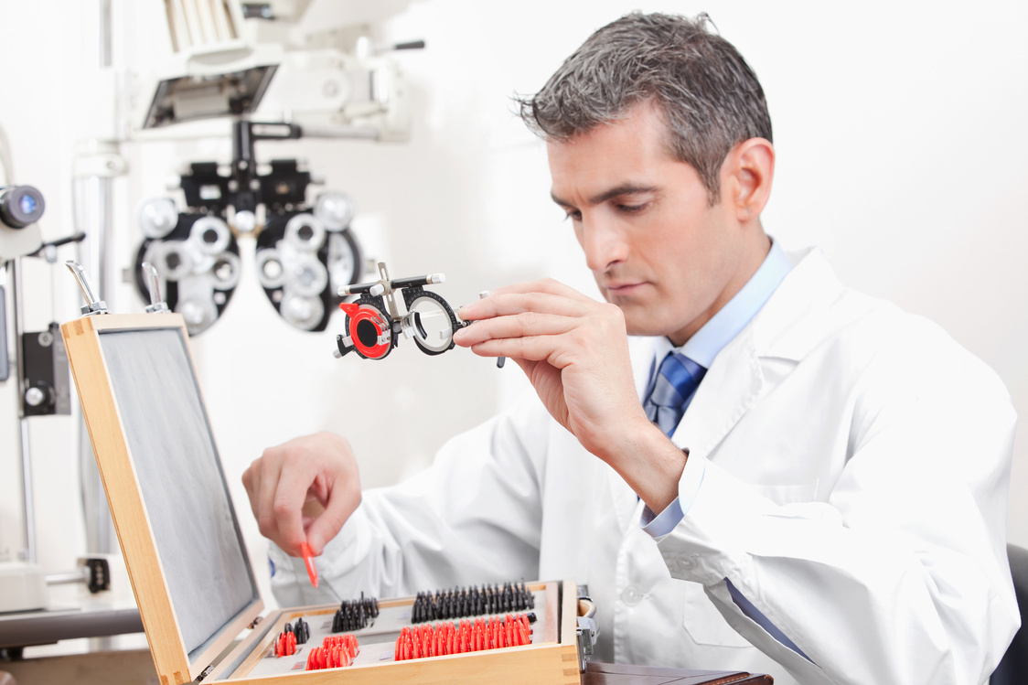 Optometrist Holding Measuring Eye Glasses